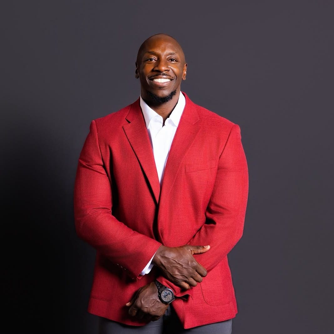 Formal professional headshot of Vernard Jenkins II in a navy suit